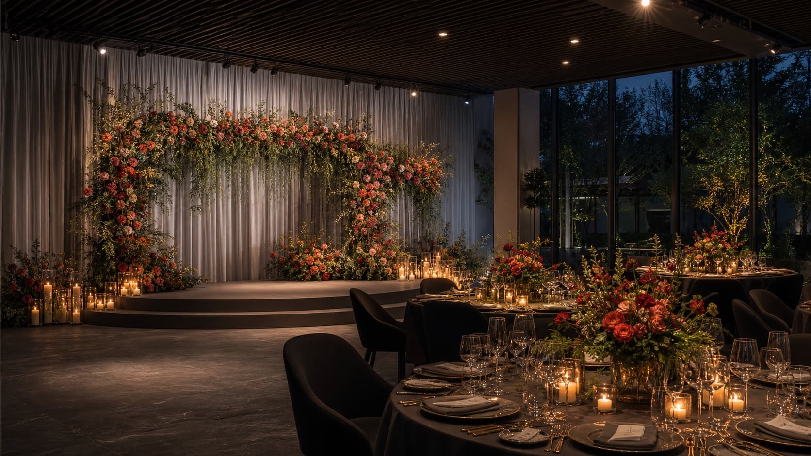 Candlelit wedding reception with a floral ceremony backdrop